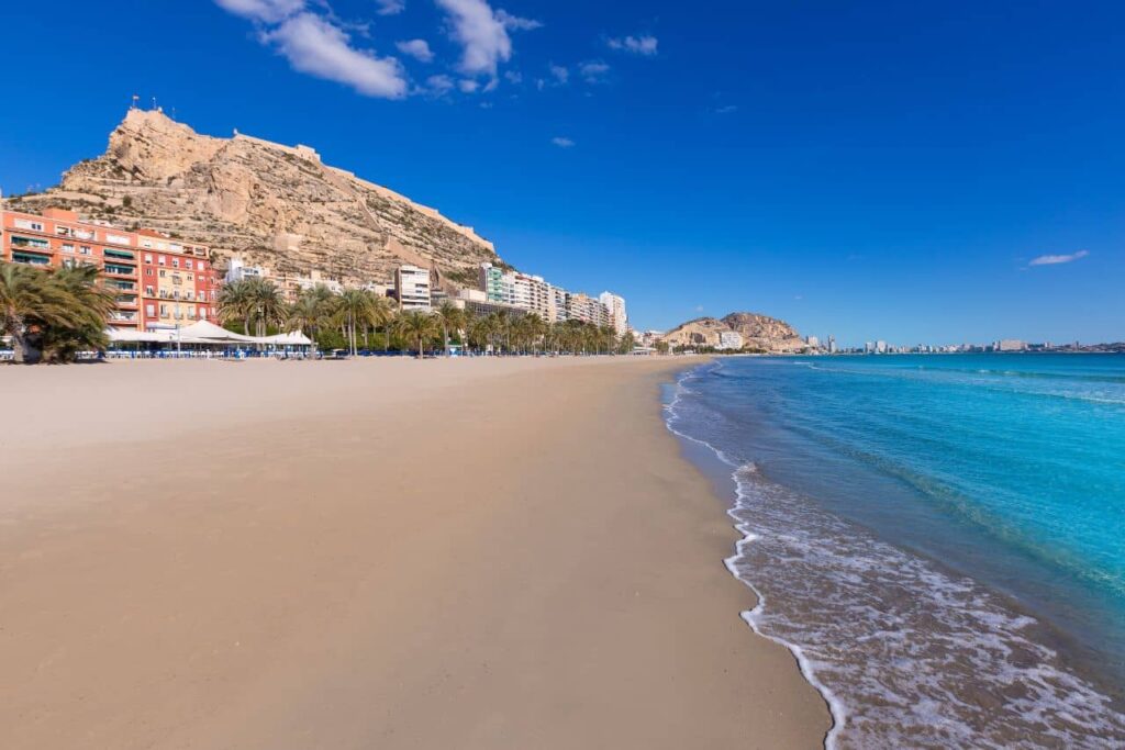 Postiguet beach in Alicante with views of Santa Barbara Castle and the Moro face.