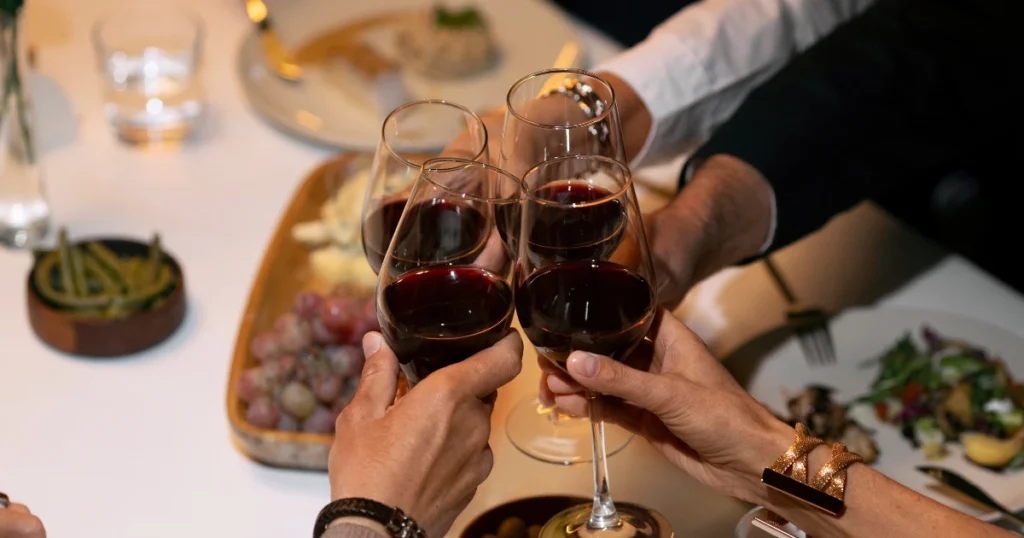 Image showing a group of people at a celebration or dinner, toasting with a glass of wine. A sample of the lifestyle in Spain suitable for foreigners.